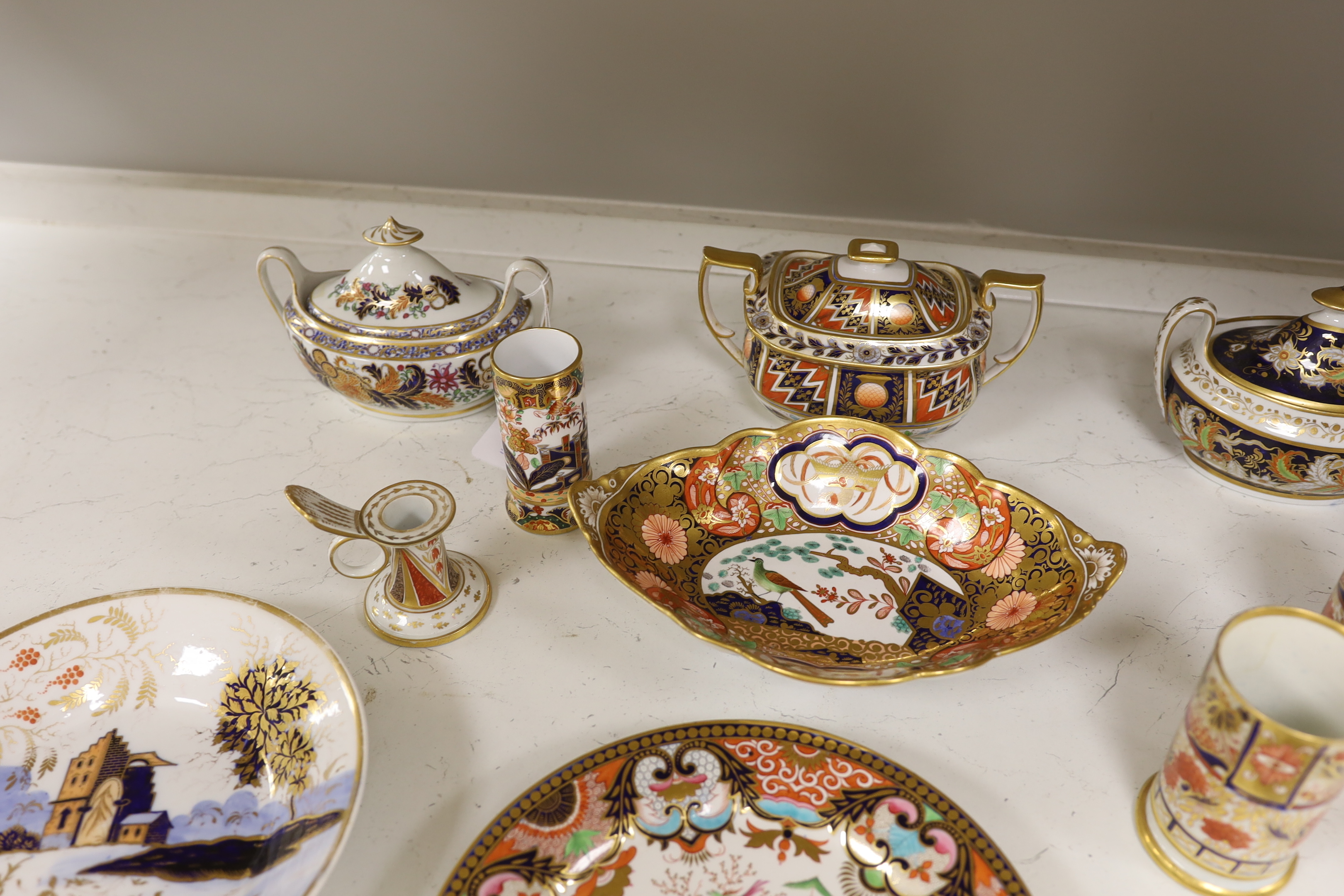 Sixteen mixed items of 1800-1820 English porcelain tableware, to include: three sucriers and covers, an oval ornately decorated dish, four saucer dishes, a candle holder, three spill vases and four saucers